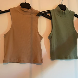 Två stycken toppar. - Två toppar en grön och en rosa. Båda är helt oanvända.  Storlek:XS/S