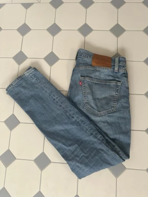 Levi's 511 ljusblå jeans W31 L32 - Säljer ett par klassiska Levi's 511 jeans i ljusblå denim. Modellen är slimfit. Grymt skick, inga defekter. Storlek 31/32. Nypris 1599kr. Vårat pris 499kr. Skriv vid minsta intresse!