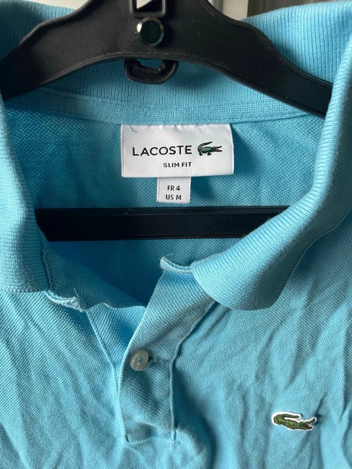 Ljusblå Lacoste piké