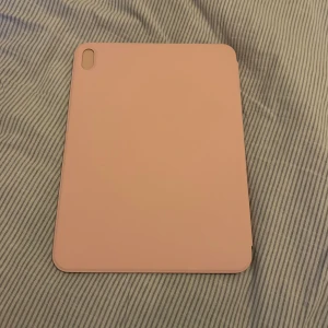 Rosa iPad fodral magnetisk flip - Snyggt rosa fodral till iPad med magnetisk flipfunktion. Passar 10th och 11th (A16) gen. Endast använt en veckans väntan på annat skal så i mycket fint skick. Inga speciella skavanker 