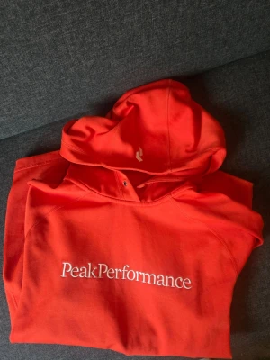 Orange tröja från Peak Performance - Snygg orange hoodie från Peak Performance. Gott skick storlek S. Fin färg!