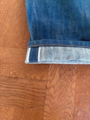 Selvedge jeans - Jag på bilden är 189/85 kg byxorna är i princip helt nya Snygga blå jeans med rak passform och klassisk femficksdesign. Jeansen har en tydlig selvedge-kant vid uppviket och är gjorda i kraftigt denimtyg. Perfekta för en avslappnad och stilren look.