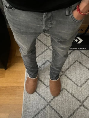 Grå slim fit jeans från Jack & Jones - Säljer ett par gråa slim fit jeans från Jack & Jones, modell Glenn. Jeansen har en snygg tvättad look och smal passform som sitter tajt längs benen. Perfekta för dig som gillar en modern och stilren stil.