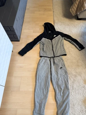 Grå och svart Nike dress i storlek L 147-158cm. - Säljer ett par grå svart Nike dress.