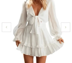 Vit kort omlottklänning med volang - Supersöt vit kort klänning med omlottdesign och knyt framtill. Klänningen har långa, luftiga ärmar och volangdetaljer på kjolen. Perfekt för sommarens alla tillfällen och ger en romantisk vibe. Tillverkad i ett lätt och skönt material. Köpt för 549 använt cirka 2 gånger priset kan diskuteras ❣️