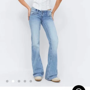 Ljusblå bootcut jeans från Gina Tricot - Säljer ett par helt nya ljusblå bootcut jeans från Gina Tricot som är low waist. Jeansen har en snygg tvättad look med en ”cut off” midja.