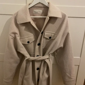 Kappa - En beige kappa med band som passar perfekt nu till våren💗skulle säga att den passar mellan xs-m beroende på hur man vill den ska sitta 