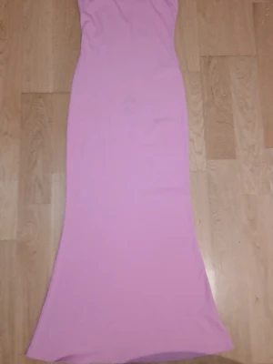 Två långa klänningar i pastell - Säljer två långa klänningar i mjukt material, en i ljusrosa och en i ljusblå. Båda har smala axelband och figurnära passform som faller snyggt längs kroppen. Perfekta för sommarens alla tillfällen.