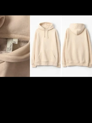 Beige hoodie från MyTRENDU - Snygg beige hoodie från MyTRENDU i mjukt material med klassisk huva och dragsko. Hoodien har en stor magficka framtill och ribbade muddar vid ärmslut och nederkant. Perfekt för en chill och avslappnad stil.