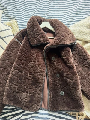 Brun kappa från Gina Tricot - Pälskappa från gina med skinndetaljer. Endast använd 3 gånger. Nypris cirka 600kr. Hör av er för fler frågor. Den är oversized så passar både S och XS.