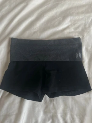 VS fold over shorts  - Sjukt snygga och basic fold over shorts från Victoria’s Secret. Super sköna. Svarta och gråa med två vingar i höften. Inga synliga skavanker som jag kan se. 