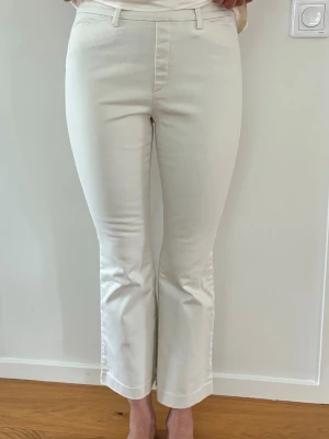 Benvita byxor Uniqlo stl XS Nyskick - Offwhite byxor från Uniqlo Heattech. Stl XS, passar en 36 bra. normalhög resårmidja ( jättesköna) och lite kick flare ankellånga ben. Byxorna har fickor fram och bak samt hällor för skärp. Jätteskön o fin kvalitet bomull viscose elastan. Använda ett fåtal ggr, är i nyskick. Nypris 499kr 