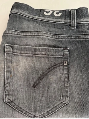 Grå jeans Dondup - Säljer ett par grå skinny fit jeans från Dondup. Jeansen är knappt använda och är i ett valdigt bra skick. Storlek 33