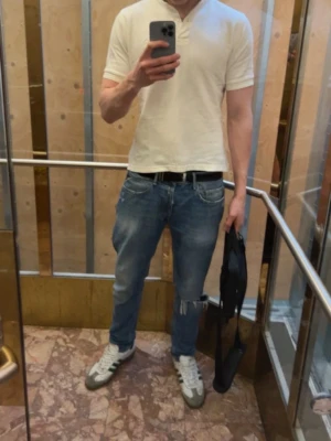 Blå Replay jeans med slitningar - fräscha blå jeans från Replay, modell Willbi. Jeansen har en snygg tvätt med slitningar på knääna. bomull, relaxed fit och raka ben. Perfekta för vår och kommande sommar när du vill ha en chill men ändå stilren look.