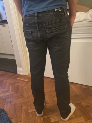 Svarta slim fit jeans från DONDUP - Säljer ett par svarta slim fit jeans från Dondup. Jeansen har en något tvättad look och är av modellen George. Strl 31 men sitter 30