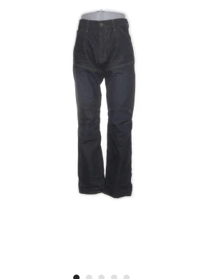 G-star jeans  - Snygga mörkblå jeans med raka ben och markerade sömmar över knäna. Klassisk femficksmodell med bälteshällor och knappgylf. Jeansen har en stilren look och är tillverkade i kraftigt denimtyg.