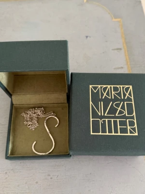 Maria Nilsdotter bokstav halsband S - Super fint bokstavshalsband från Maria Nilsdotter. Kedjan är 40 cm lång. Finns ej kvar så vet ej exakt nypris. Låda medföljer och smycket är i bra skick