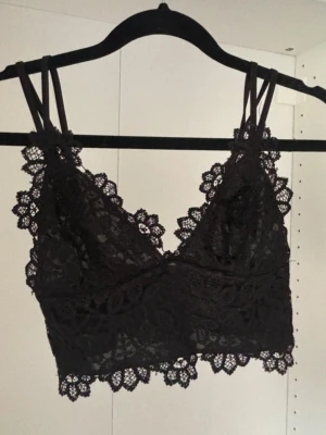 Svart spetstopp - Reglerbara band i bak. Lite liten i storleken skulle jag säga, använt någon enstaka gång så iprincip nyskick.