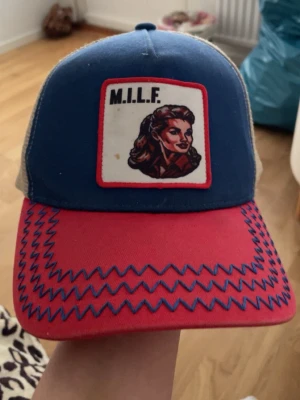 Blå och röd truckerkeps med patch - Säljer min ”Milf hunter keps” ifrån Revenite kepsen går inte att få tag på längre om man vill köpa en ”Ny” då reventine har lagts ner. Kepsen är skön och snygg. Kepsen har inte används ofta alls kanske runt 5-9 gånger. Säljer kepsen för 800 pga det går inte att få tag på kepsen som ”Ny” pris kan diskuteras.