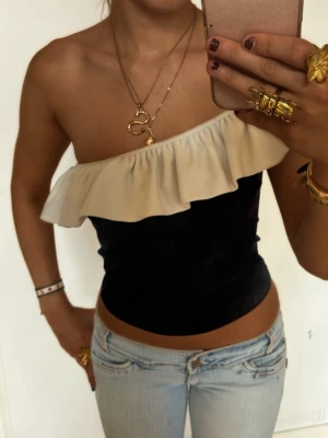 Svartvit one shoulder topp med volang - Så söt svartvit one shoulder volangtopp! Jag är 168 och det är mina bilder, köp via köp nu direkt eller Swish, kvar tills markerad som såld 💖 
