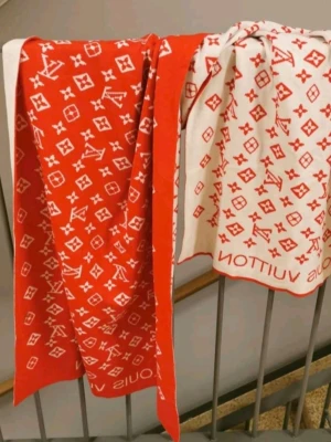 Classic red/white scarf - Stylish scarf with classic monogram in red and white and logo. The scarf has a soft and luxurious feel, perfect for lifting your outfit. The material feels like a blend of wool and cotton. Unisex and goes with many styles.