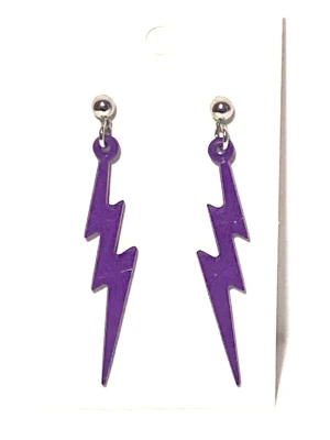 Lila blixtformade örhängen - Säljer ett par coola örhängen i form av lila blixtar. De har en blank yta och hängs i små silverfärgade örhängen  nickel fria.  Plast länk.                                           Längd  7cm