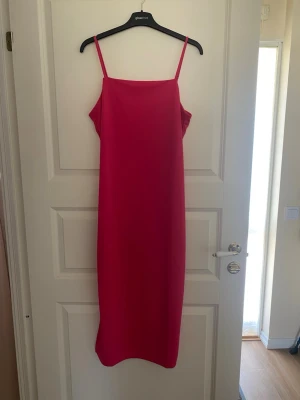 Rosa långklänning med smala axelband - En stilren rosa långklänning från H&M med smala axelband och rak passform. Klänningen är tillverkad av 100% återvunnen polyester och har en minimalistisk design som ger en modern look. Kolla gärna mina andra annonser❗️