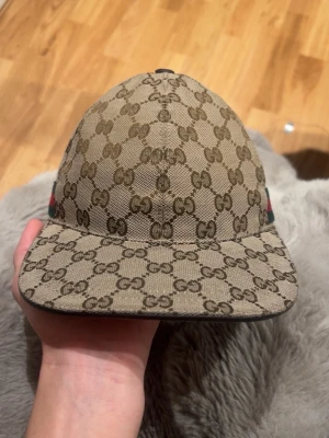 Beige gucci keps canvas - Äkta Gucci keps, gamla modellen, köpt 2020, finns Gucci chip i den men ofungerande då den är gammal, inga andra tillbehör kvar, har digital kvitto från säljaren som jag köpte ifrån här på Plick.