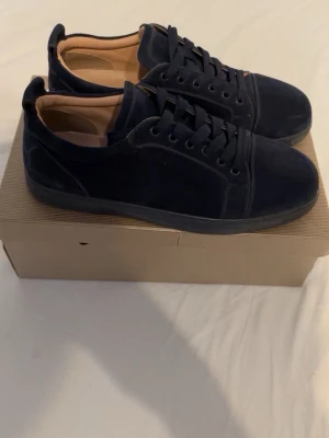 Mörkblå mockasneakers med låg profil - Stilrena mörkblå sneakers i mocka med lågt skaft och matchande mörkblå snörning. Insidan är ljusbeige och sulan är diskret svart. Perfekta för dig som gillar minimalistisk och clean stil.