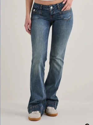Super-low ”heart pocket” bootcut jeans - Ett par jätteeee snygga bootcut från Nelly som har jätte gulliga fickor. Helt oanvända och helt nya.