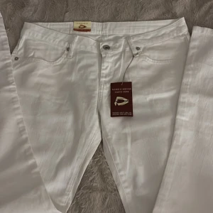 Vita Dallas Jeans bootcut dam - Snygga vita jeans från Dallas Jeans med klassisk femficksdesign och broderade bakfickor. Lapparna är inte kvar och på sista bilderna syns lite missfärgning längst ner på benen och en liten fläck på bakfickan som knappt syns💓Perfekta för dig som är lång! Passar mig som är ca 172💝
