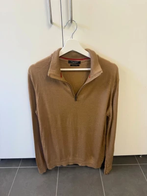 Luca Nobili Beige halvzip tröja i extra fin merinoull, stl XL - Snygg beige långärmad tröja med halvzip och hög krage. Tröjan har en stilren design och är tillverkad i ett tunt, mjukt material som passar perfekt till lager-på-lager. Perfekt för dig som gillar en clean och klassisk look.