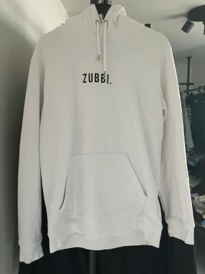 ODZ Hoodie Vit Storlek S - ODZ Hoodie Vit Storlek: S Passform: Regular fit Krage: Hög krage med huva Material: Bomullsblandning Skick: Hoodien är i ett bra skick med vissa defekter/fläckar som syns på bild Nypris cirka: 600 kr