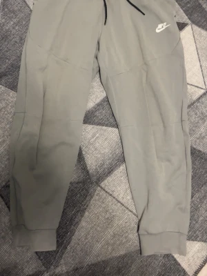 Grey nike tech fleece pants - Used but in good condition!!                      No holes or any problems.