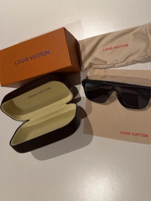 Louis Vuitton solglasögon - Snygga svarta solglasögon från Louis Vuitton. Kommer med originalfodral, putsduk och box. Perfekt accessoar för dig som vill sticka ut med exklusiv stil.