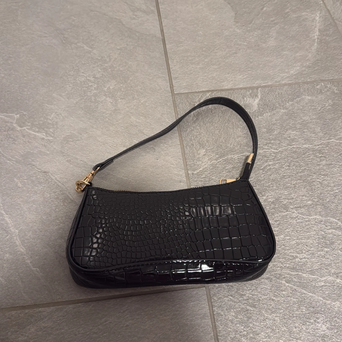 Svart axelväska med krokopräglad yta