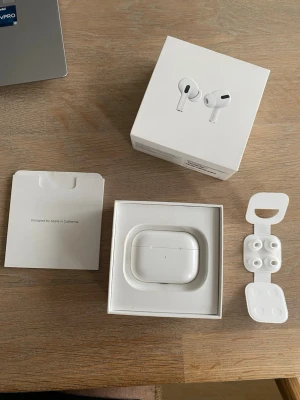 Apple AirPods Pro with Wireless Charging Case - Säljer ett par Apple AirPods Pro med trådlöst laddningsetui. Komplett med originalförpackning, extra öronproppar och manual. Hörlurarna är i gott skick men har mindre spår av användning på laddningsetuiet. Aktiv brusreducering och hög ljudkvalitet.