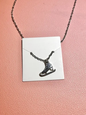 Halsband skridsko - Ett silvrigt halsband från guldfynds julkalender 2024 med en skridskoberlock. Aldrig använt🩶