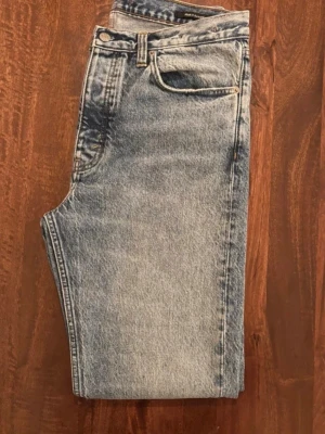 HOPE Blend Jeans i ljusblå denim - unik  - Säljer ett par Blend Jeans från HOPE i ljusblå tvättad denim. Klassisk femficksmodell med raka ben och normal passform. Jeansen har hög midja och tydliga sömmar, perfekt för dig som gillar en clean och tidlös look. Unik färg. 