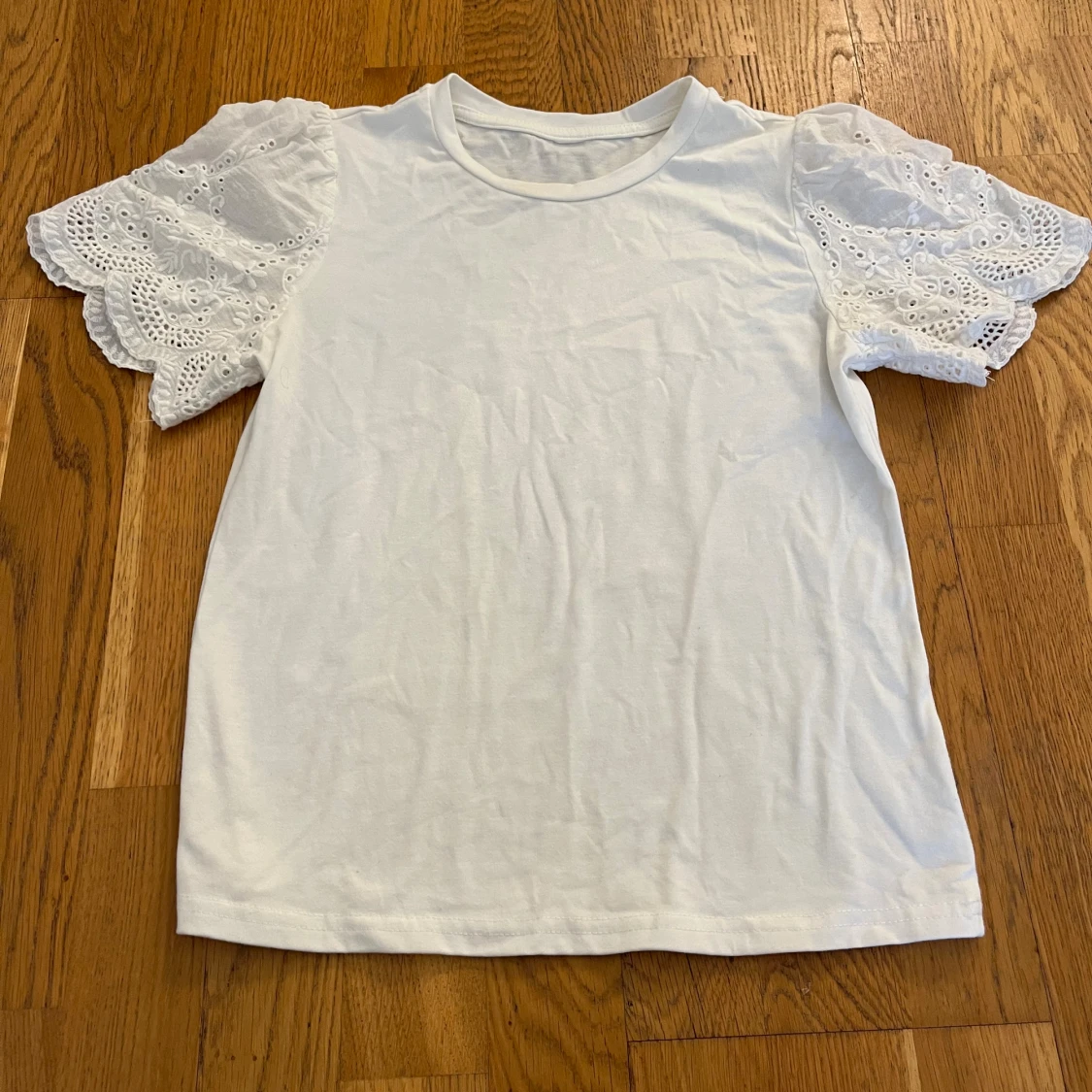 Vit topp med broderade volangärmar