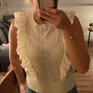 Vit volangblus - Supersöt vit blus från Holly & White med broderade volanger på axlarna. Säljer då den inte kommer till användning hos mej💕
