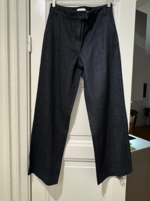 Wide leg jeans from H&M in waist 32inch  - Never used wide leg jeans from H&M. Comes with front pleats detail and two pockets at the back.  Color: dark blue  Waist: 32”  Total length: 42”  Width of 1 leg: 12”   Tag says euro 38 but I guess it’s bigger to size or low waist. 32inch is the the measurement when measured by tape.   Please check my other listing to get bundle offer!