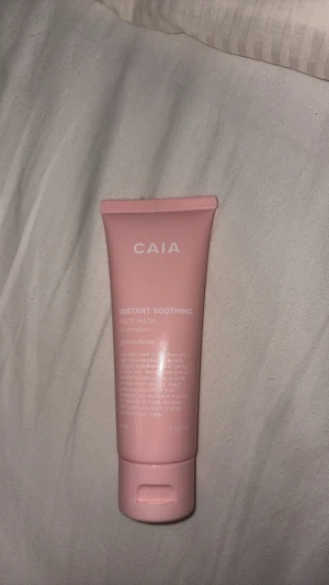 CAIA Instant Soothing Face Mask - Säljer en rosa tub med CAIA Instant Soothing Face Mask för normal hud. Innehåller glycerin och allantoin som ger huden fukt och lugnar. Tuben rymmer 75 ml och har en praktisk skruvkork. Perfekt för dig som vill ha en mjuk och återfuktad känsla.