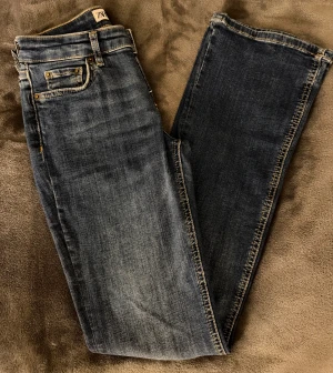 Blå bootcut jeans från Zara - Blåa low waist jeans från Zara i storlek 34. De bra stretch och sitter väldigt bekvämt. De har en smalare bootcut form. Använt ca 2-3 gånger så nästan helt nya. Jag är 163 cm lång för preferens. Hör gärna av dig vid frågor💙