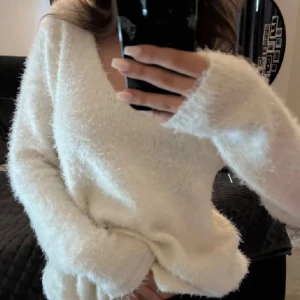 Vit fluffig stickad tröja - Supermjuk och fluffig vit stickad tröja från Gina Tricot med v-ringad hals och långa ärmar. 