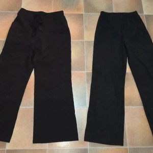 2-pack Svarta Palazzobyxor / Vida Byxor - Resår & Knytdetaljer (Strl S) Dam - Säljer ett paket med två par svarta, vida byxor i storlek Small (S). Båda byxorna är i trendig Palazzo-stil med vida ben och hög komfort. Perfekt baspaket för att variera din look!