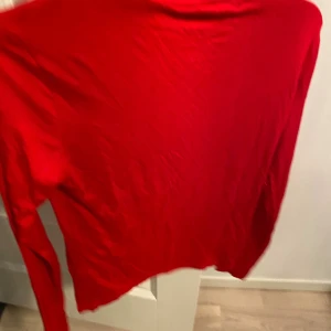 Röd polotröja från Gina Tricot - Snygg röd polotröja från Gina Tricot i storlek M. Tröjan har lång ärm och en klassisk polokrage, perfekt för att ge din outfit en färgklick. Materialet är mjukt och lätt, vilket gör den skön att bära. Enkel och stilren design utan mönster eller detaljer.