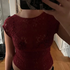 Röd spetstopp öppen rygg - En röd spets topp med öppen rygg från stradivarius, knappt använd. Den är i storlek L men sitter mer som en M.