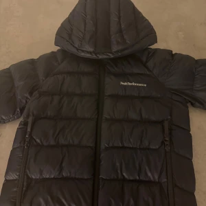 nästan ny Svart dunjacka Peak Performance 140 -  NY PRIS 1999 mitt pris 1000 Snygg svart dunjacka från Peak Performance med huva och dragkedja. storlek 140 pris kan gå ner