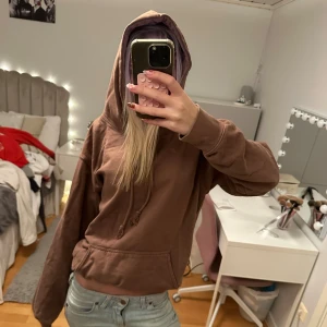 Brun hoodie  - Säljer en brun hoodie med stor huva och snörning framtill. Tröjan har en klassisk känguruficka och är långärmad med en loose passform. Perfekt för chill dagar och enkel att matcha med jeans eller mjukisbyxor. Skrynklig då den legat i garderoben länge!